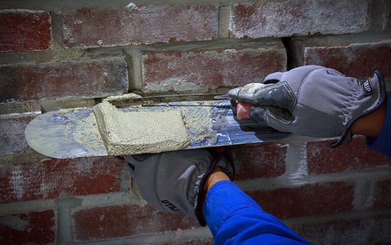 Spot and tuck pointing on a brick chimney